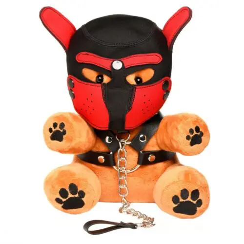 Brown teddy bear wearing a red and black muzzle.