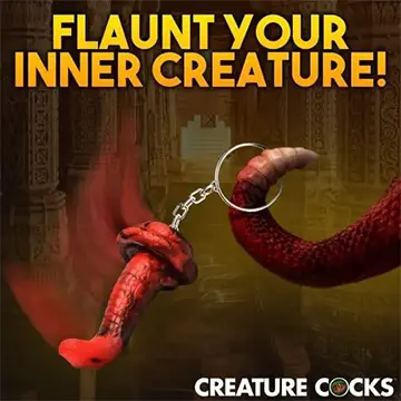 Red snake tail keychain on a gold chain.
