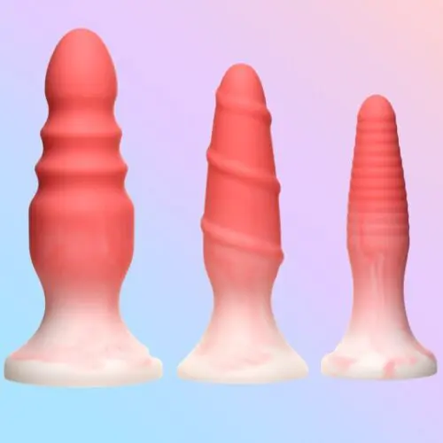 Three pink silicone butt plugs.