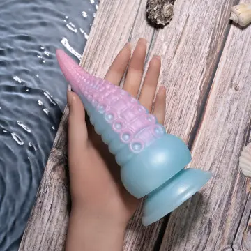 A person holding an octopus shaped toy in their hand.