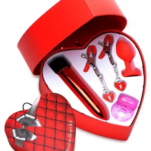 A heart shaped box with various items inside of it.