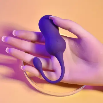 Purple silicone toy resting on a hand.