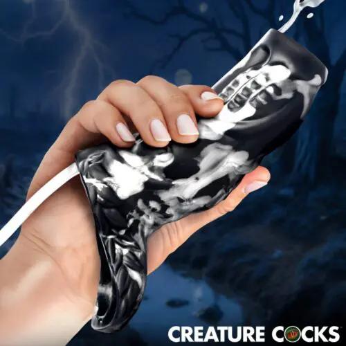 A hand gripping a shiny, black, creature-like object with mechanical features.