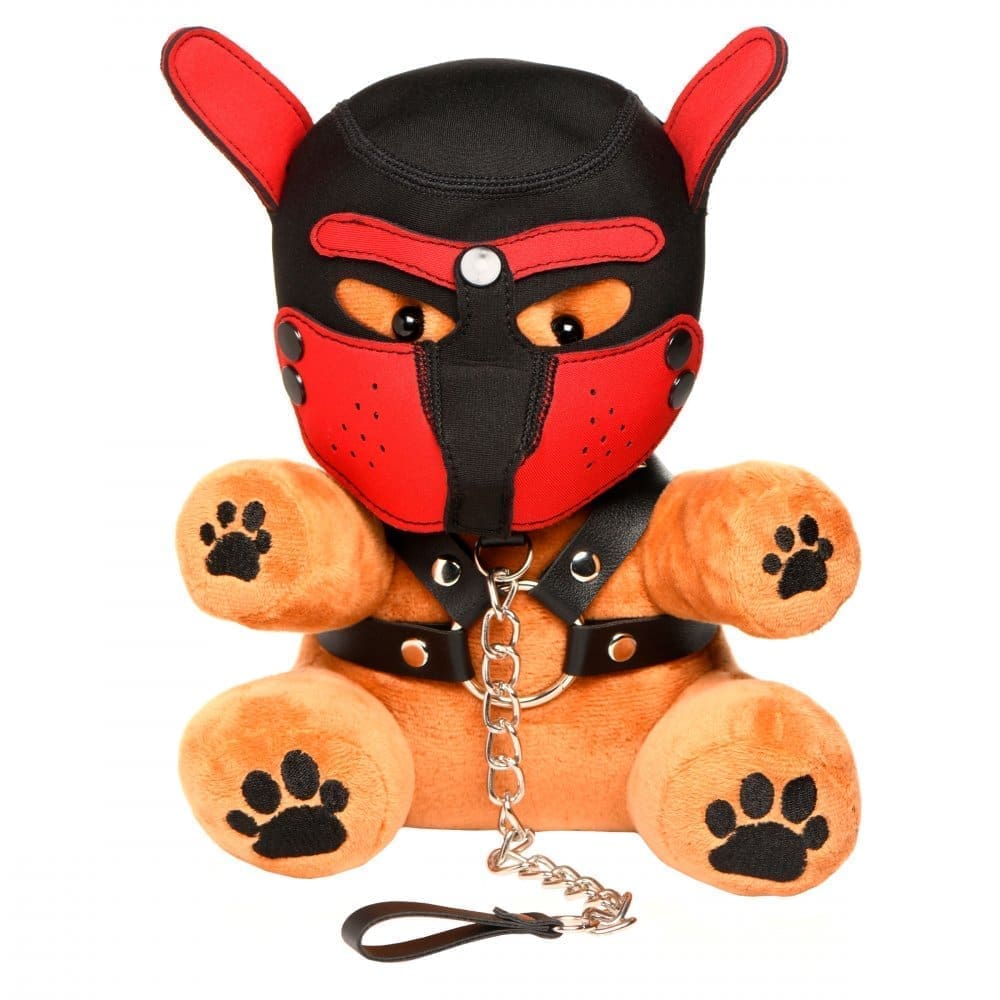 Brown teddy bear wearing a red and black muzzle.