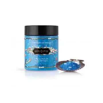 Blue bath salts in a jar with a seashell.
