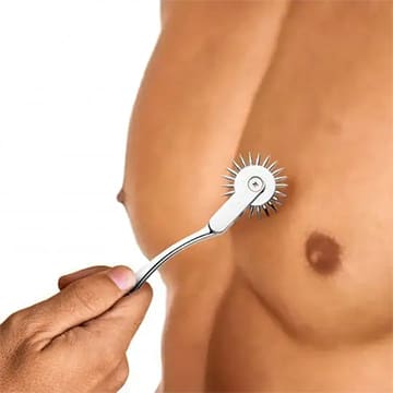 A man shaving his chest with an electric razor.