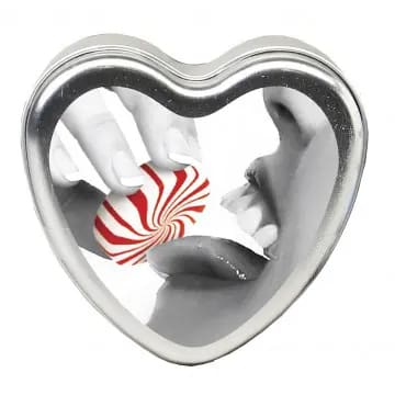 A heart-shaped tin with a candy.
