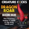 Red dragon-shaped silicone dildo on base.