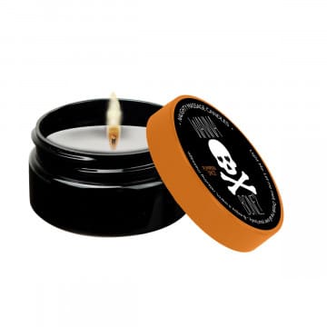 Black and orange skull candle with flame.
