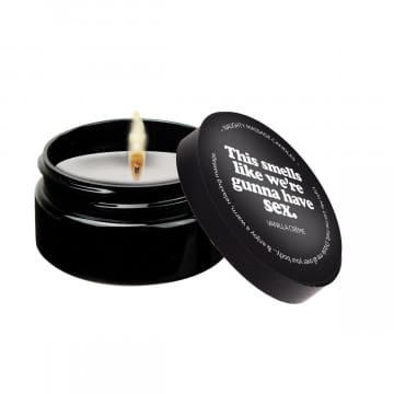 Black candle in glass jar with label.
