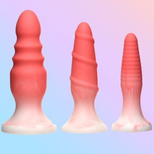 Three pink silicone butt plugs.