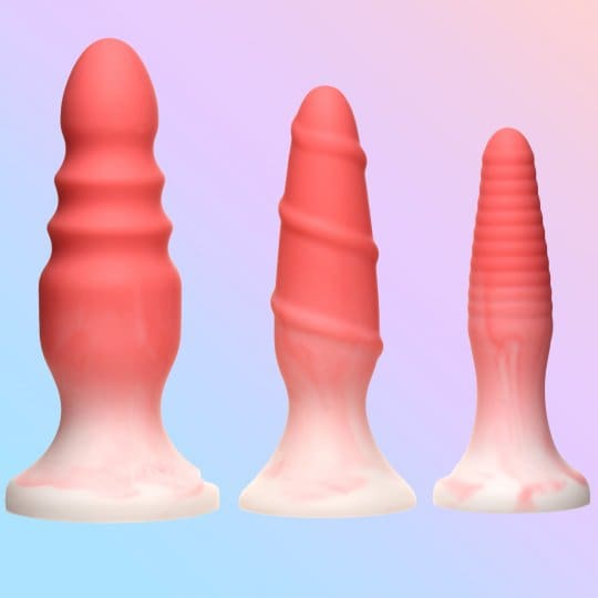 Three pink silicone butt plugs.
