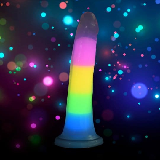 Rainbow silicone sex toy on a dark background.