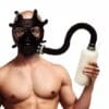 Man wearing gas mask holding bottle