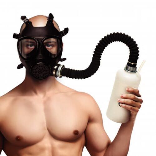 Man wearing gas mask holding bottle