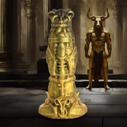 A gold statue of a man with horns and a demon.
