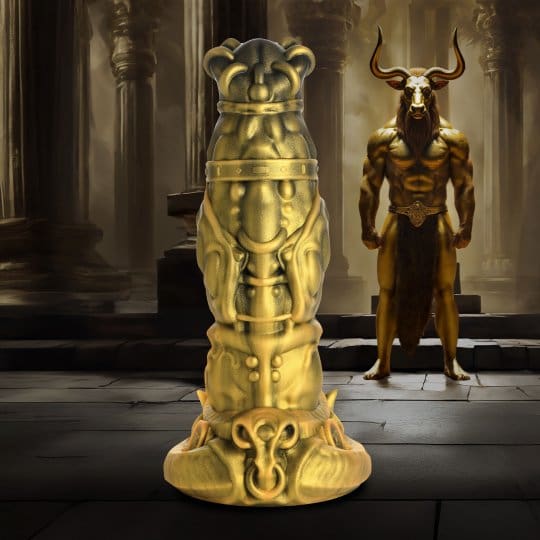 A gold statue of a man with horns and a demon.