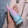 A person holding an octopus shaped toy in their hand.