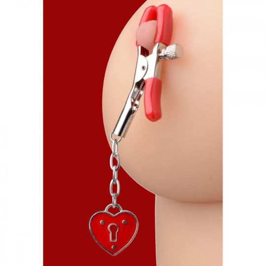 A red heart shaped key chain hanging from the side of a woman 's butt.