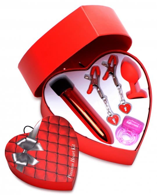 A heart shaped box with various items inside of it.
