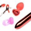 A variety of sex toys are laying out on the table.