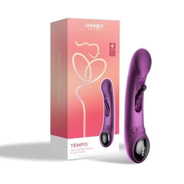 A purple vibrator is next to its box.