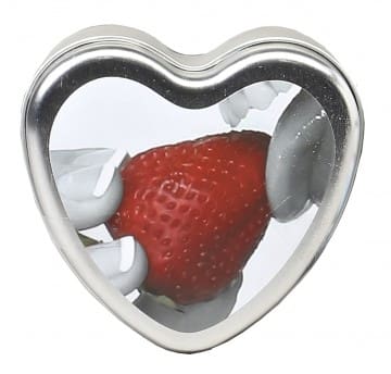 A heart shaped tin with strawberries inside of it.
