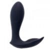 A black sex toy is sitting on top of the floor.