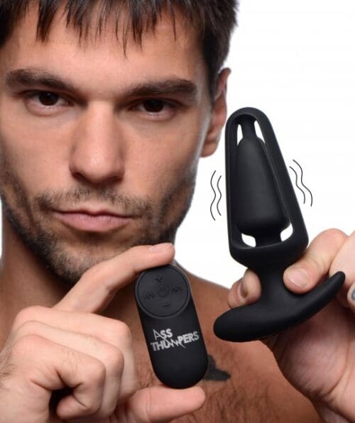 A man holding up an electronic device and another device.