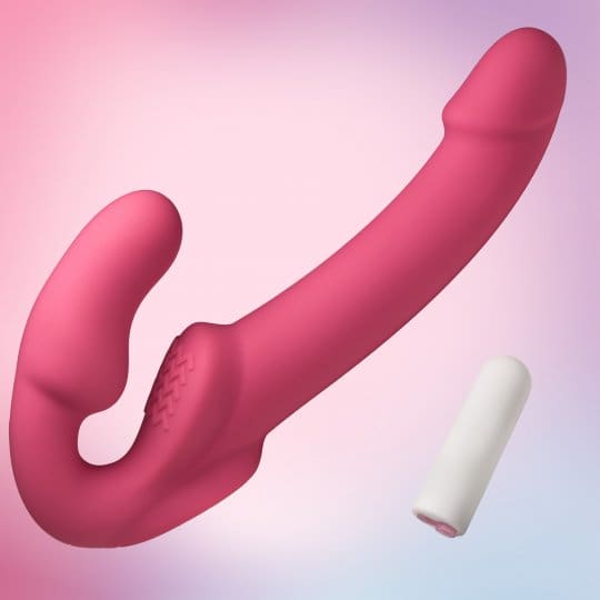 A pink and white condom is next to a pink dildo.