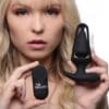 A woman holding two different types of sex toys.