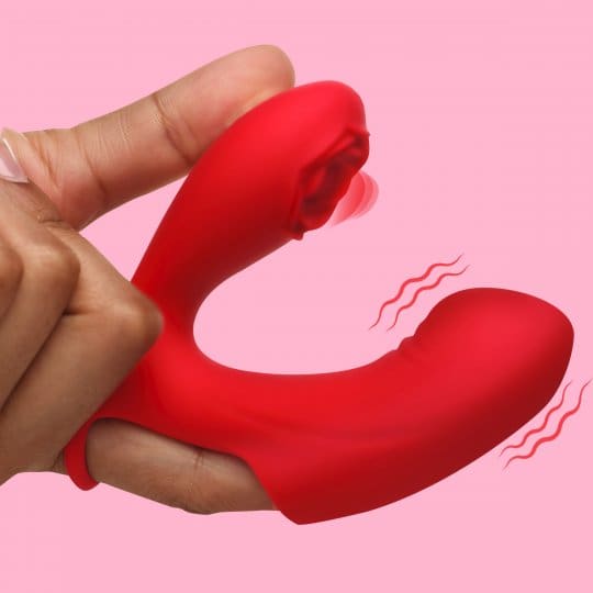 A person holding a red sex toy in their hand.
