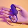 Purple silicone toy resting on a hand.